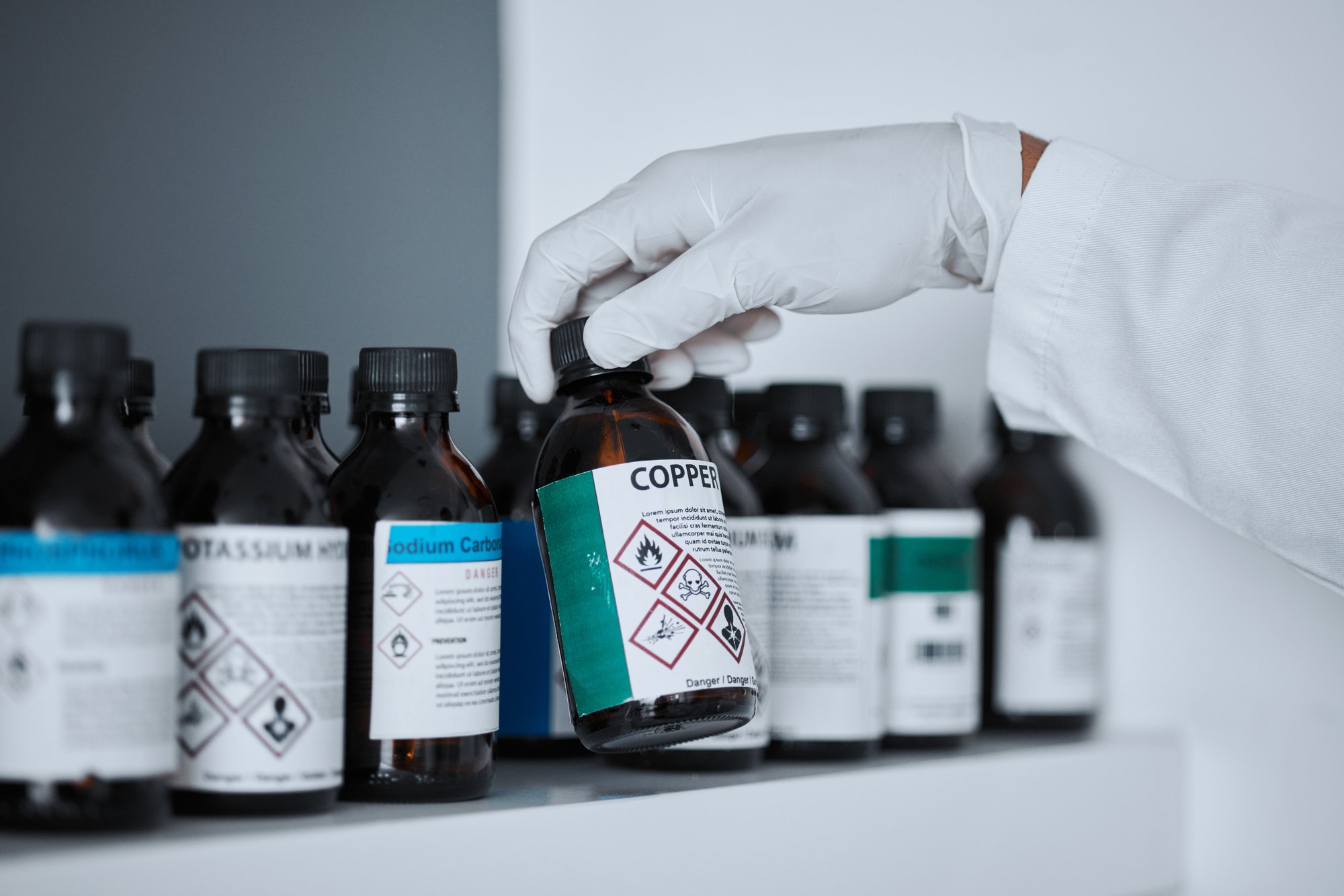 scientist-hand-bottle-and-chemical-on-shelf-in-ph-2025-04-06-12-32-10-utc (1)
